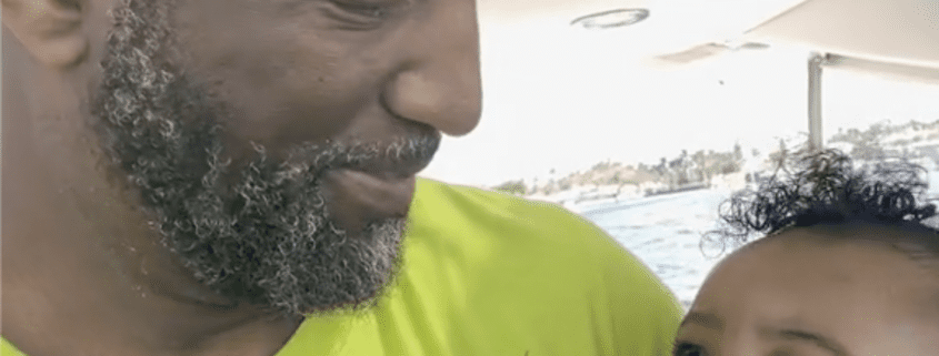 Man smiling at baby on a boat.